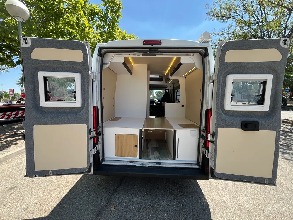 Puertas traseras abiertas de la camper Ducato L2H2 con acceso al maletero bajo la cama